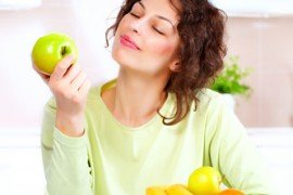 Dieting concept. Healthy Food. Young Woman Eats Fresh Fruit