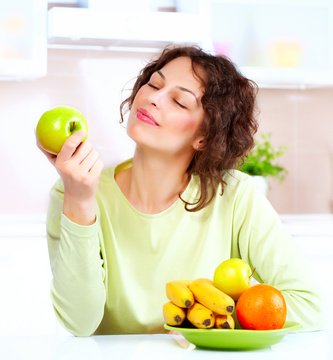 Dieting concept. Healthy Food. Young Woman Eats Fresh Fruit